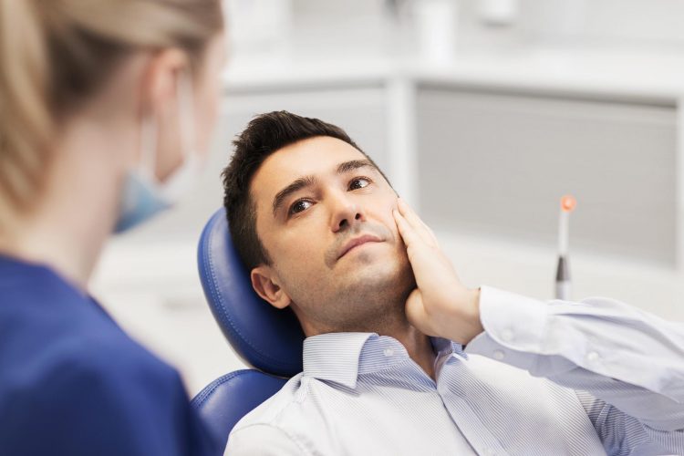 An adult patient viewing a digital dental image or scan.