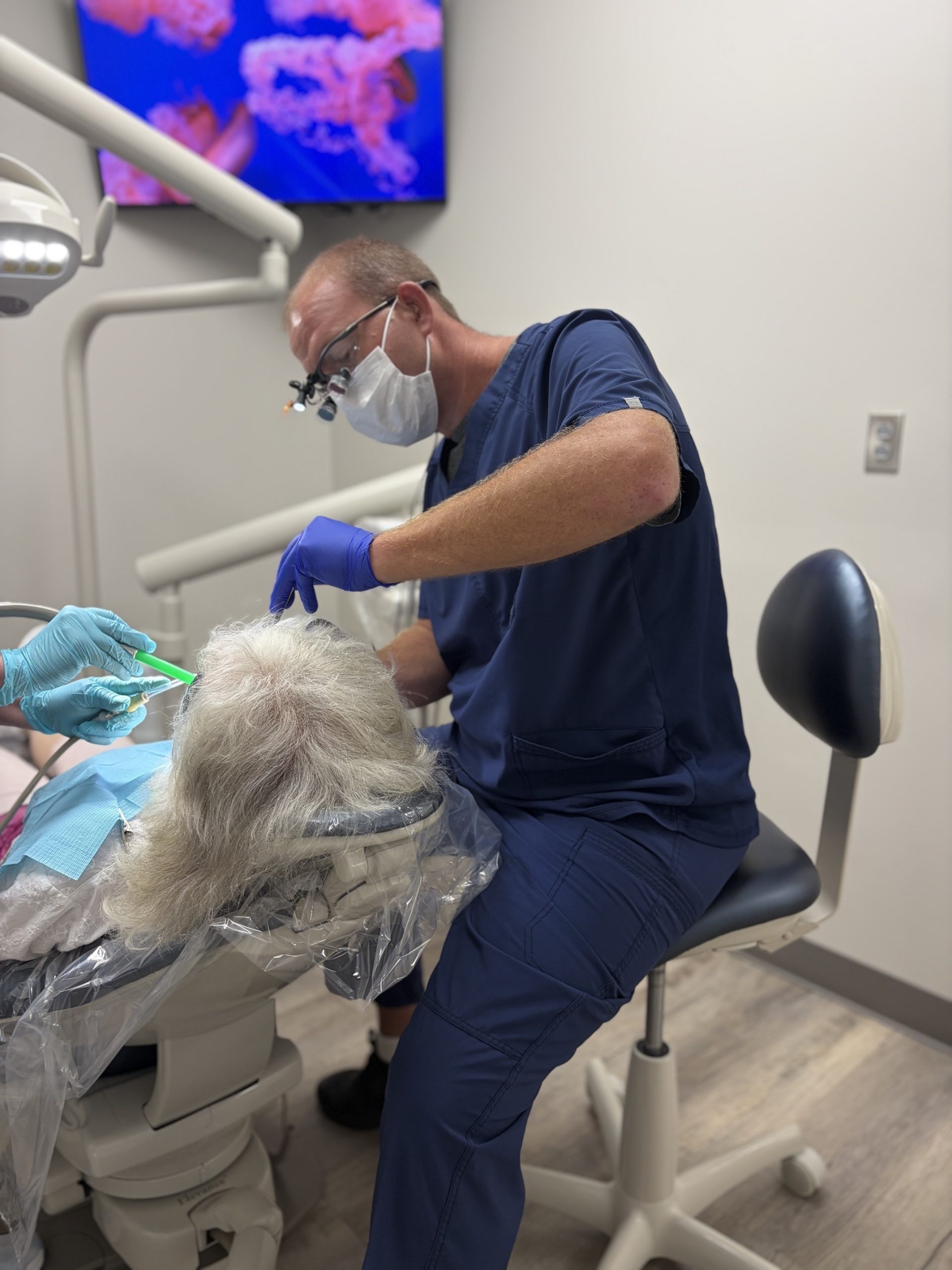 Dental hygienist performing a routine exam and cleaning